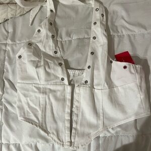 white cropped top that clasps in the front and ties around neck. size large